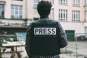 Bulletproof Hosting - Journalist wearing bulletproof vest
